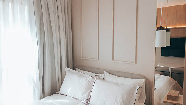istock Serene Cozy Bedroom with Fabric Curtains and Warm Natural Light 2249247695