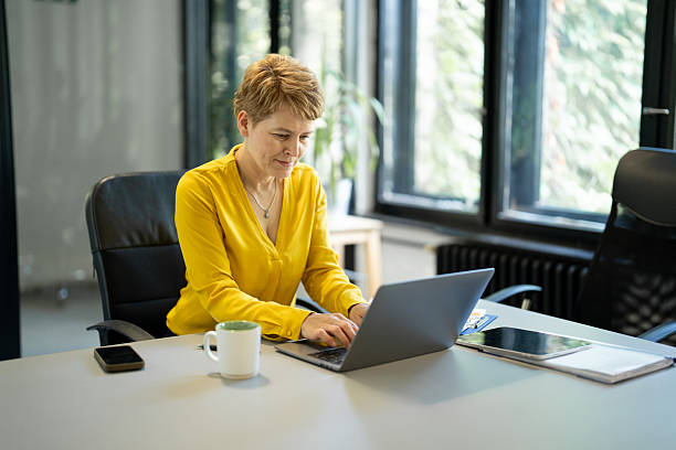istock Professional woman working on laptop in office 2249247760