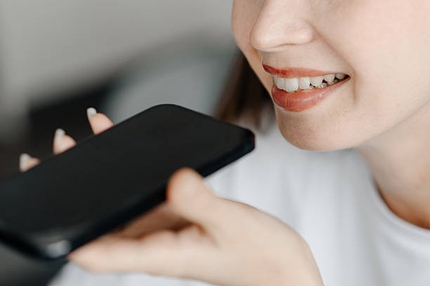 istock young beautiful woman records voice message 2249248138