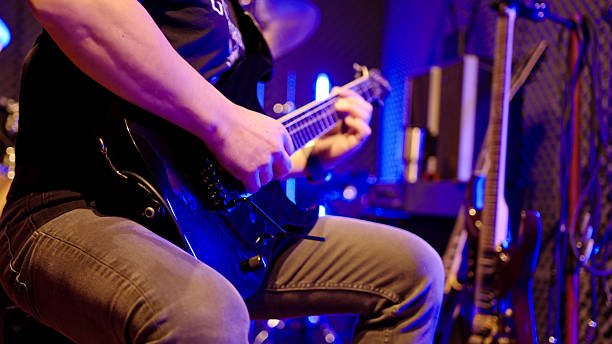 istock Excited Guitarist Playing Guitar In Studio With Neon Lighting 2249249521