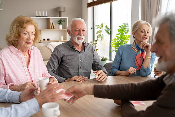 istock Elders engaged in a card game over a wooden table 2249249692