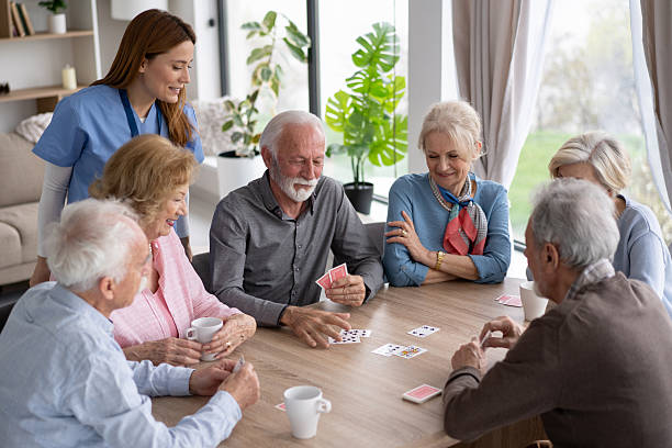 istock Caring Nurse Engaging with Seniors during Card Game Fun 2249249693