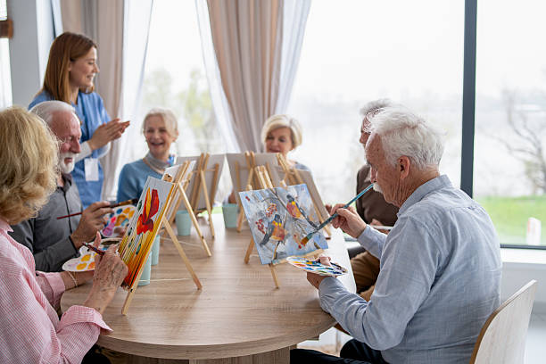 istock Seniors Enjoying a Fun Group Painting Activity Together 2249249699