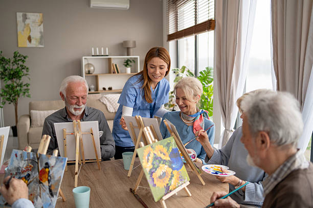 istock Group painting session with elderly at a cozy studio space 2249249702