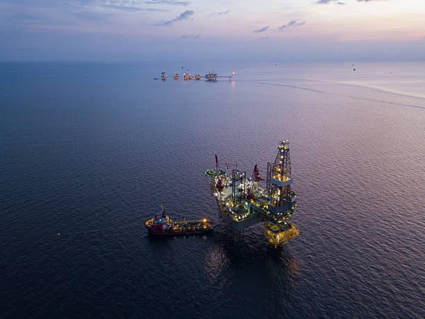 istock Aerial view offshore jack up rig at the offshore location during sunset with supply vessels and CPP 2249249738