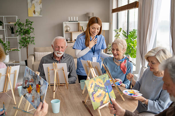 istock Seniors participating in colorful painting workshop 2249249746