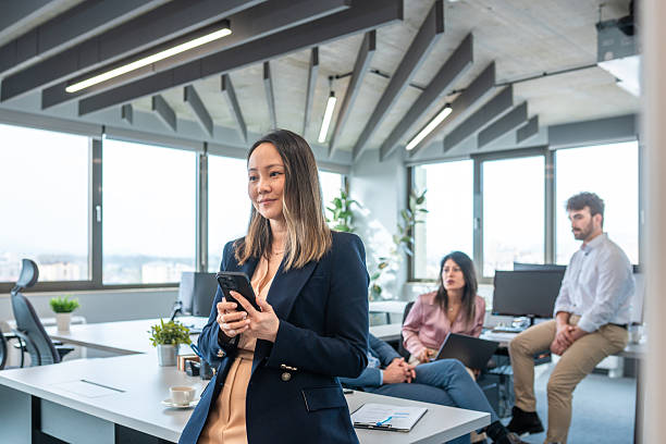 istock Professional Asian Businesswoman Using Smartphone in Office 2249249809
