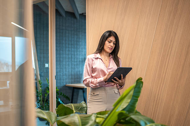istock Professional Hispanic Businesswoman Utilizing Tablet in Office 2249252024