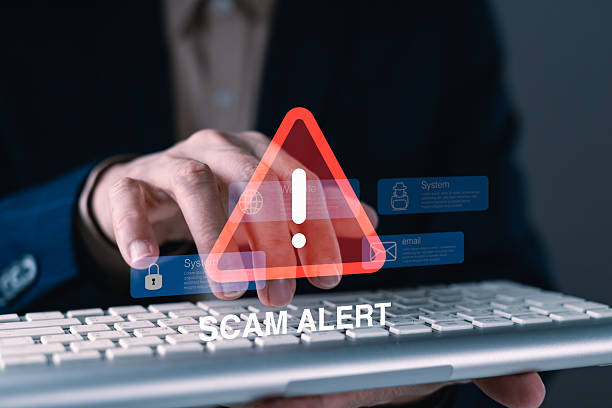 istock Scam alert warning with hand typing on keyboard and red triangle exclamation icon symbolizing cybersecurity threat and online fraud detection concept 2249252540