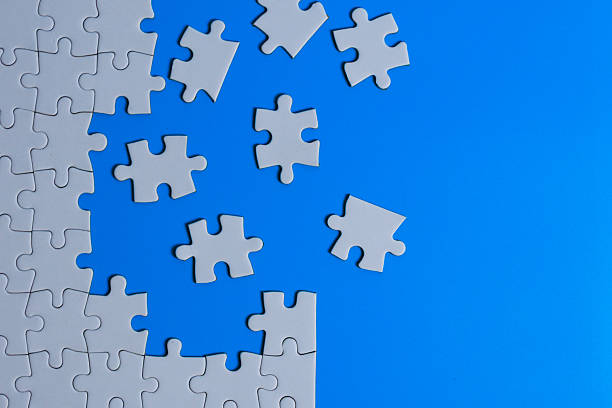 istock Scattered puzzle pieces on a bright blue background with copy space 2249253662