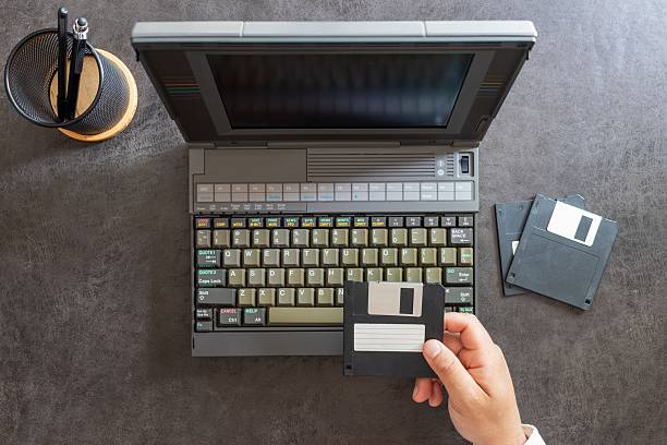 istock hands of a man working with floppy disks 2249256179