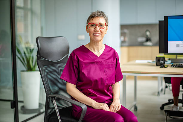 istock Healthcare worker smiling in modern hospital setting while using technology to assist patients 2249257420