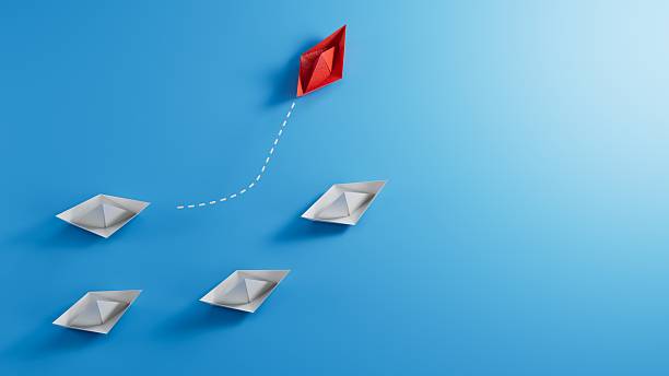 istock New ideas creativity and different innovative solution. Business concept. A group of paper ships, one boat is flying in the other direction, different way. 2249259117