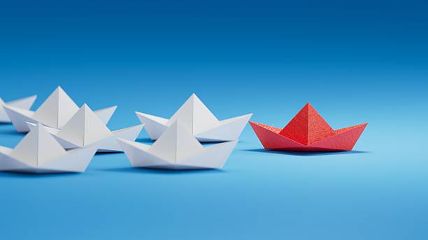 istock Different business concept.new ideas. paper art style. creative idea.Leadership concept, red leader boat leading white boats.3D rendering on blue background. 2249259129