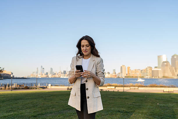 istock Woman using mobile phone outdoors 2249259213
