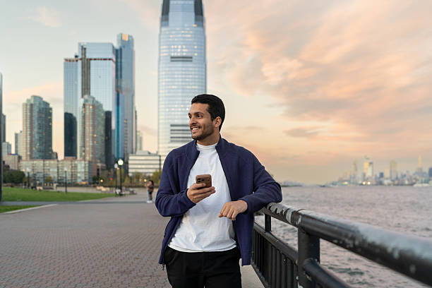 istock Latin man using mobile phone outdoors 2249259343
