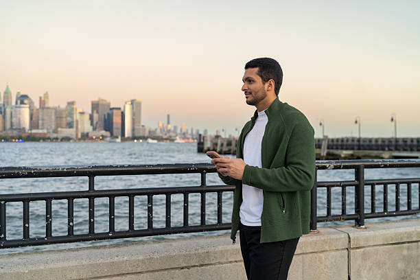 istock Latin man using mobile phone outdoors 2249259351