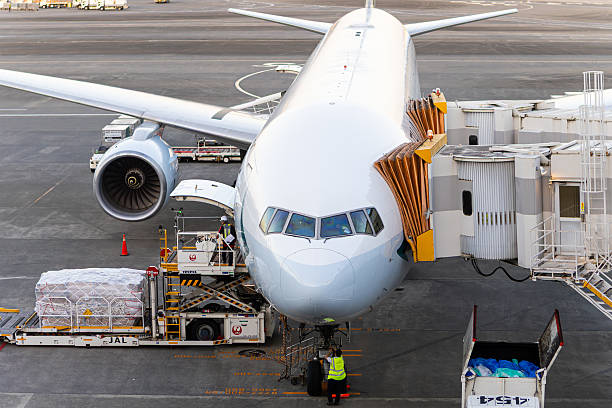 This image is of a Cathay Pacific Airways Boeing 777 parked at the gate at Narita airport in Japan. Cathay Pacific's regional 777-300 configuration has 42 business class seats in a 2-3-2 recliner-style layout and 396 economy seats in a 3-4-3 layout, for a total of 438 passengers.