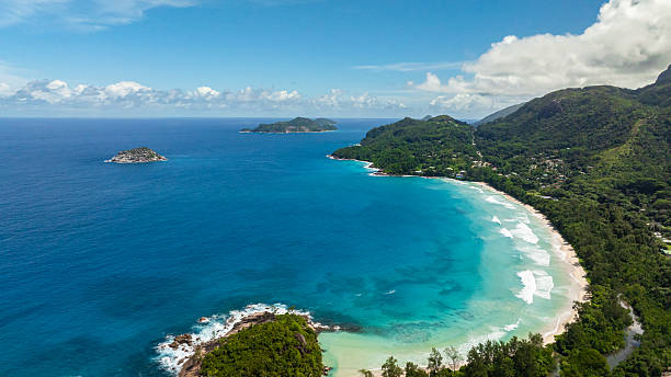 istock Panoramic ocean view with lush green hills and distant islands. Seychelles, Mahe. 2249261360