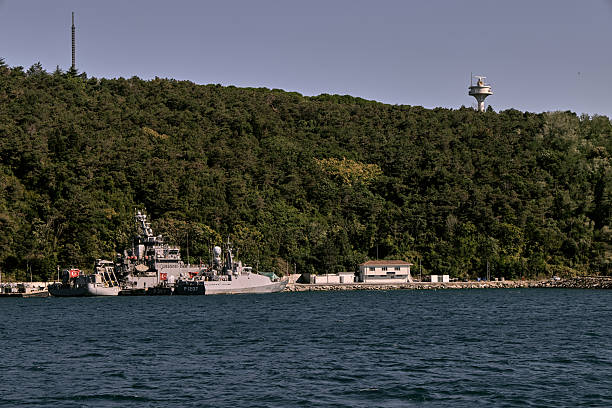 Istanbul, Turkey - December 05, 2025: A view of a military navy frigate navigating through the Bosphorus Strait near the Asian side coast. The Bosphorus is a significant strategic waterway connecting the Black Sea to the Mediterranean.