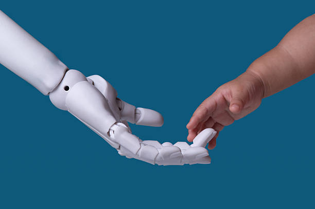 istock Future is Coming: Robot Hand and Child's Hand, Symbolizing Progress and Growth 2249264196