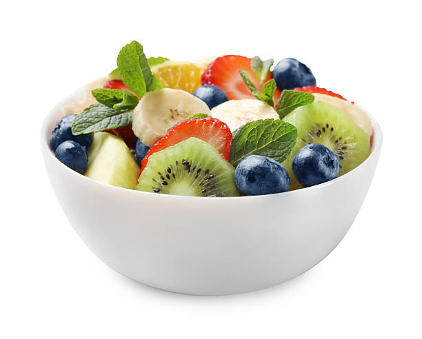 istock Tasty fruit salad in bowl isolated on white 2249264670
