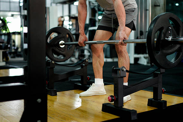 istock muscular body builder sport man is practice weight training on squat barbell for core muscle inside gym with dark background for exercising and workout usage 2249265335