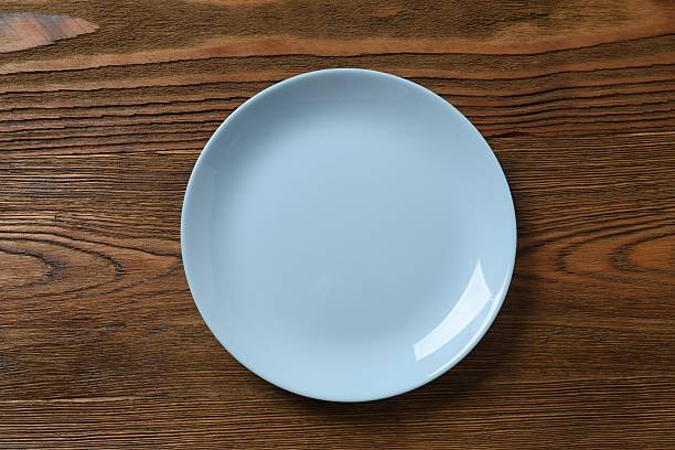 istock Top view of blue empty plate on a wooden background 2249265467