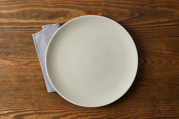 istock Empty plate with napkin on a wooden background 2249265635