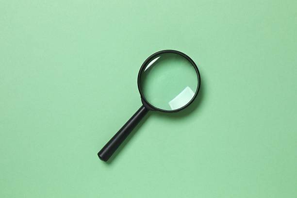istock Magnifying glass on color background 2249267158