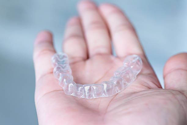 istock clear aligners device in the mouth on a white background. (invisalign) 2249267339
