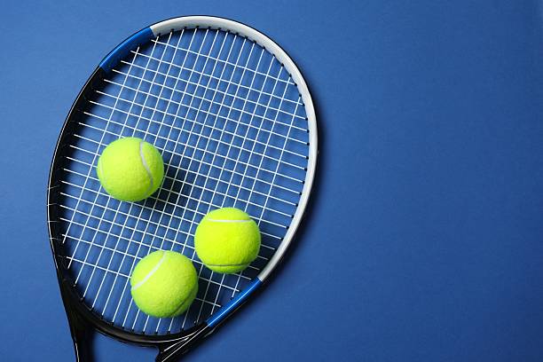 istock Tennis racket and balls on blue background 2249267545