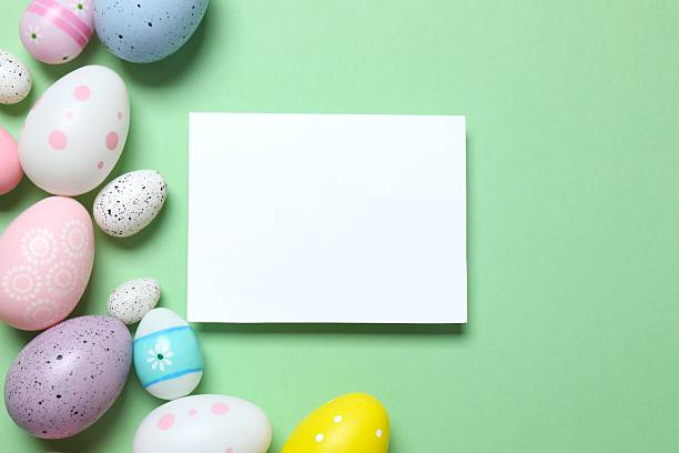 istock Happy Easter. Colorful eggs and white paper card on a pastel color background, space for text 2249268175