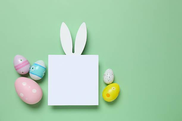 istock Happy Easter. Colorful eggs, bunny ears and paper card on a pastel color background, space for text or advertising 2249268191