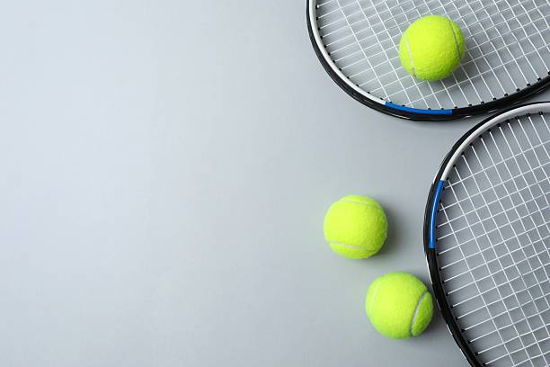 istock Tennis rackets and balls on grey background 2249268279