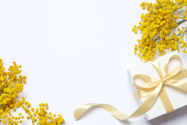istock Beautiful composition with spring mimosa branches and gift box on a white background 2249268868