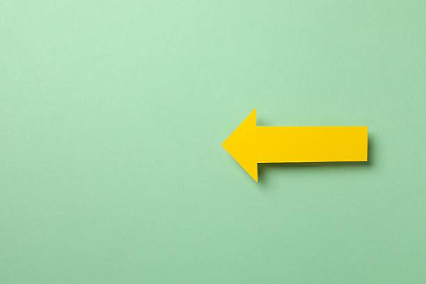 istock Paper arrow on color background, top view 2249269202