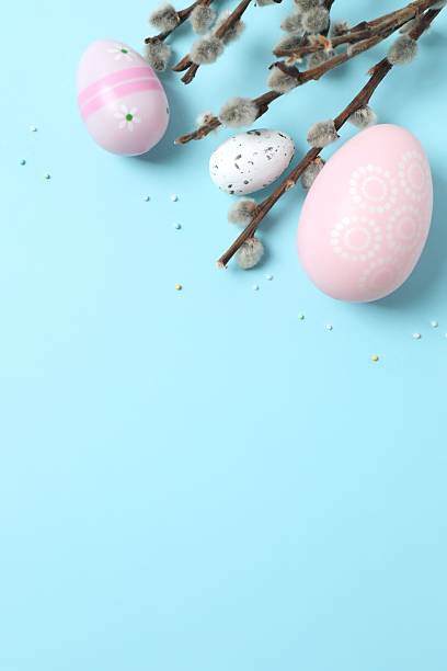 istock Vertical view of colorful eggs and pussy willow branches on a pastel blue background, space for text or advertising 2249269472