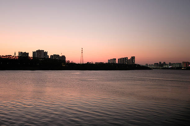 istock Serene Waterfront Cityscape at Dusk with Reflected Skyline 2249269520