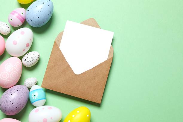 istock Happy Easter. Colorful eggs with paper envelope on color background, space for text or advertising 2249270152