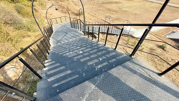istock Steep outdoor metal staircase casting shadows in sunlit environment 2249271549