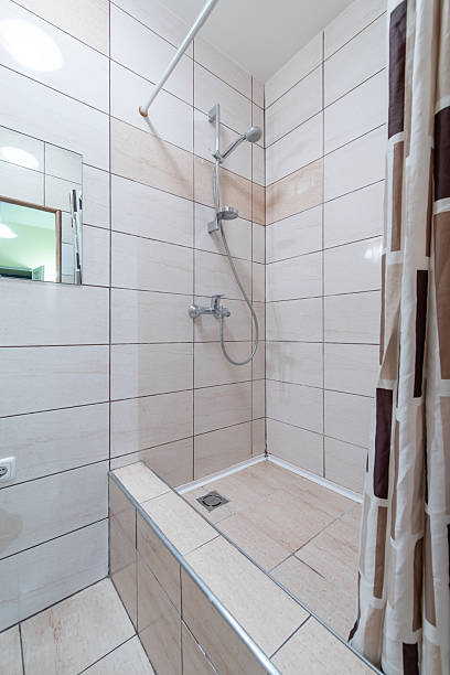 istock Modern Shower Cabin with Beige Tile Wall and Clean Shower Setup 2249274095
