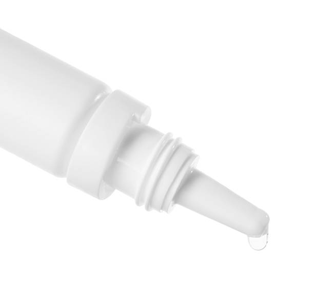 istock Dripping medical drops from bottle on white background 2249274473