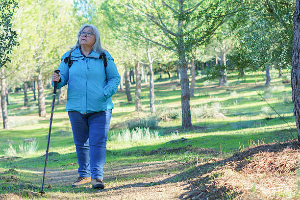 istock Senior woman enjoying forest hike with trekking pole 2249276460