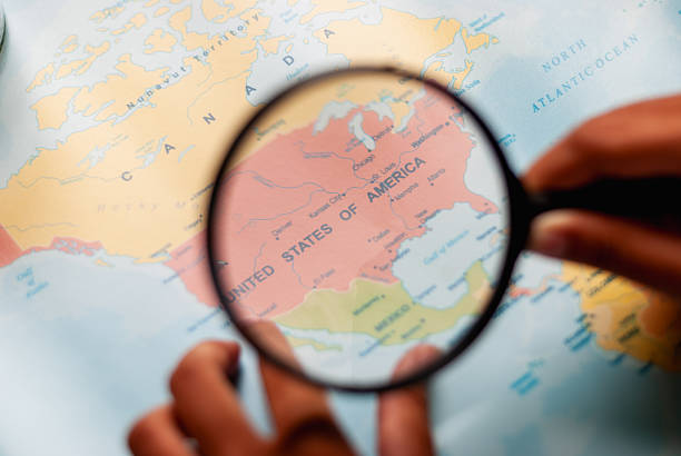 magnifying glass searching for islands over blue sky