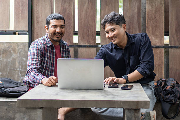 istock Two men working together in an outdoor cafe space 2249277160
