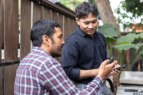 istock Two men working together in an outdoor cafe space 2249277170