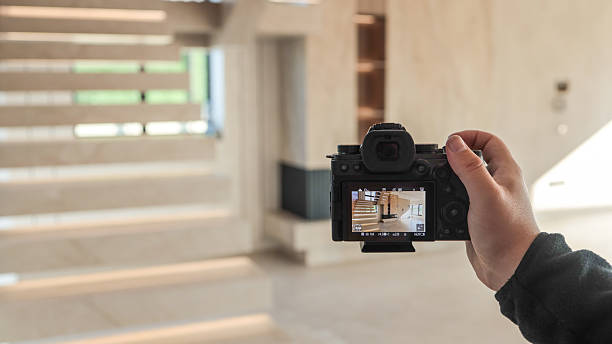 istock Photographer capturing modern interior staircase with digital camera 2249277858