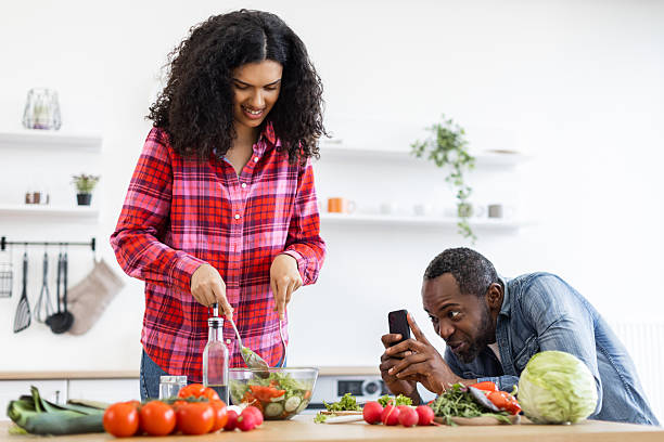 istock Couple Cooking and Taking Photos 2249277906