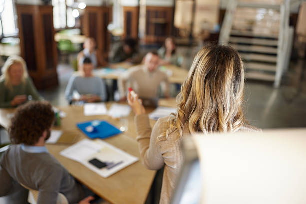 istock Back view of creative woman talking during presentation in the office. 2249277996